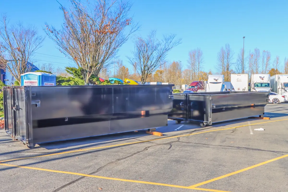 Professional dumpster rental service with roll-off container on residential driveway in North Fort Lewis